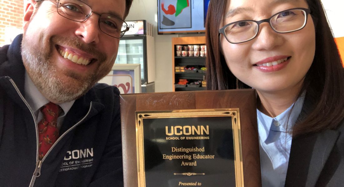 Dean Burkey and Professor Jang posing with her award for Distinguished Engineering Educator